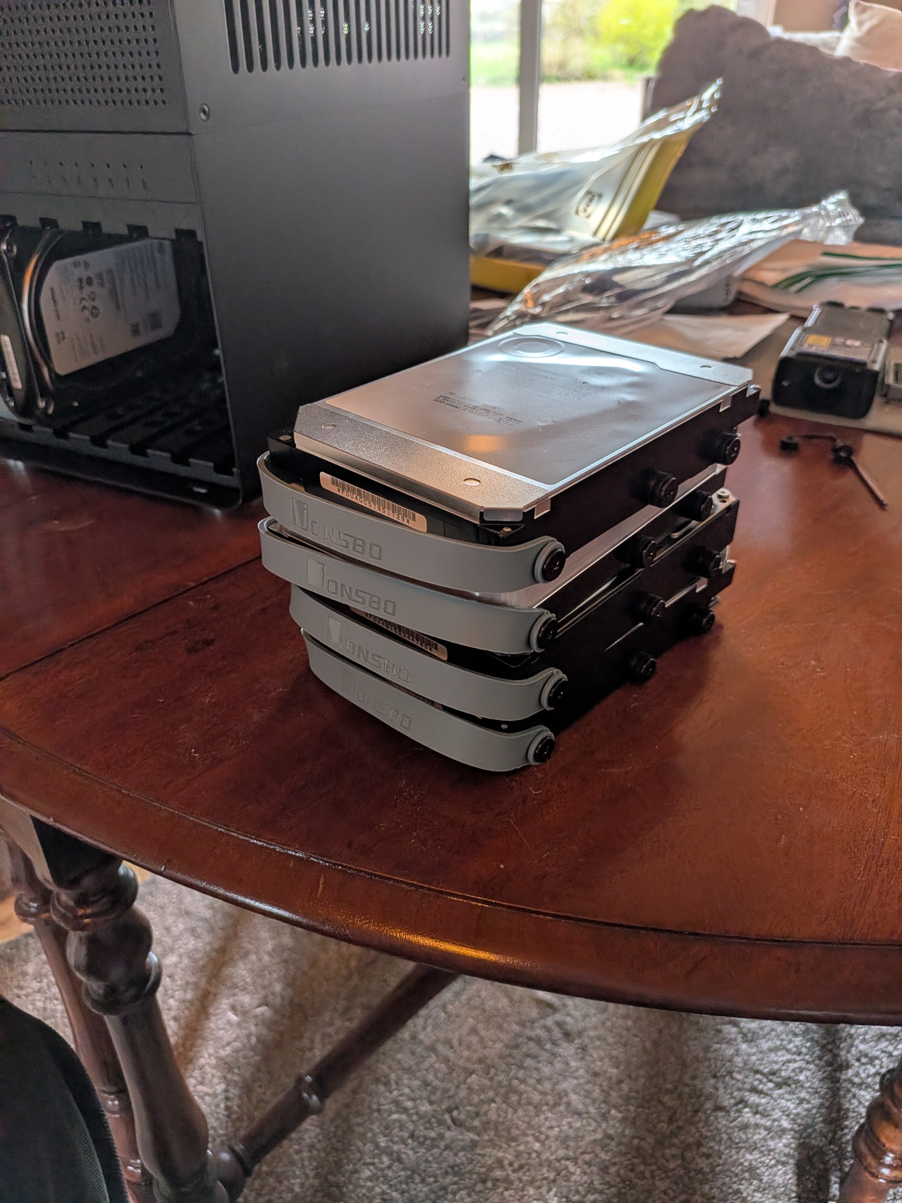 Four drives stacked on a table ready to install